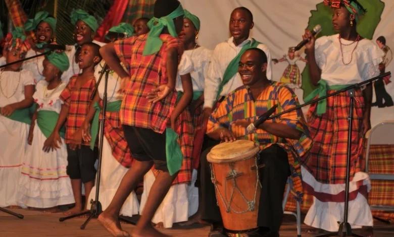 Creole drummers and dancers in traditional madras dress performing bouyon bèlè lapo kabwit